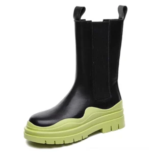 Black genuine leather mid-calf platform boots with lime green wavy thick sole, alternative fashion styling, front three-quarter angle