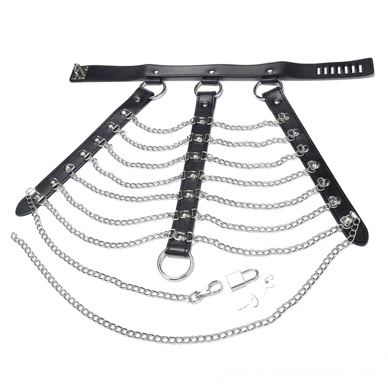 Flat lay overhead view of complete gothic chest harness with padlock, matching key, and extra chain accessories