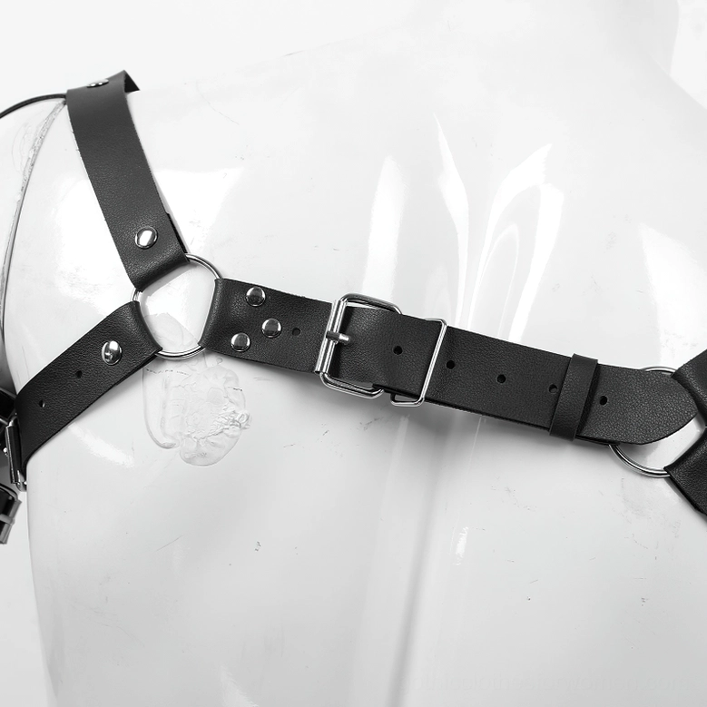 Gothic leather chest harness flat lay on solid background, complete arm-to-wrist extension visible