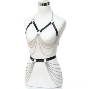 Black leather gothic chest and waist harness with layered silver chain tassels worn on white mannequin front view
