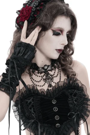 Black gothic lace choker with cross pendant and layered beaded design, three-quarter angle view on female goth model