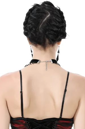Rear view of black gothic choker necklace with adjustable chain extender and matching drop earrings on female model