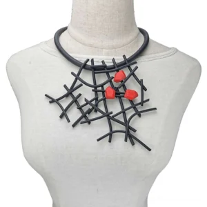 Black rubber gothic statement choker with branch framework and red wooden geometric accents on mannequin front view