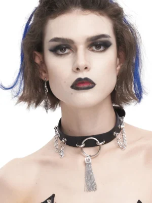 Black faux leather gothic choker with silver metal tassel pendant and studded accents worn by model with gothic makeup, frontal view