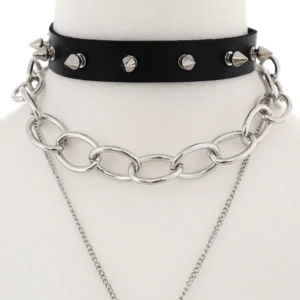 Close-up detail of black leather choker with silver cone studs and thick metal curb chain