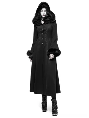 Front view of black faux fur hooded gothic long coat with ribbon disc flower detailing, modeled by woman on white background