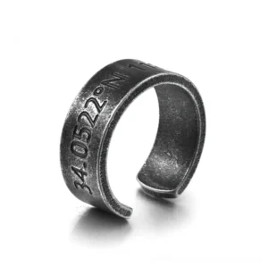 Gothic coordinate engraved unisex stainless steel ring with open cuff design, left three-quarter view showing matte black vintage metal finish