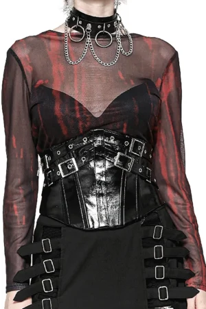 Female goth model wearing black leather corset belt with silver buckles over red sheer top, front full-body fashion photoshoot