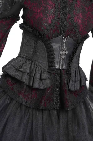 Black Victorian lace corset waist belt with cross zipper pendant and ruffled lace trim, front view worn by model