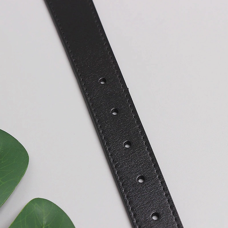 Black leather belt strap with evenly spaced pin hole adjustment points for sizing, flat lay detail