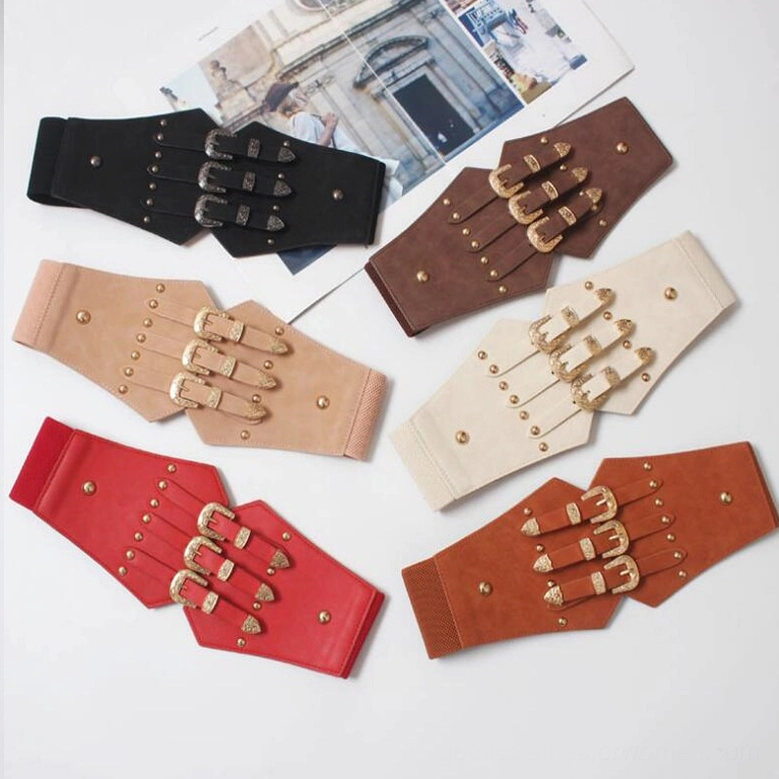 Flat lay overhead view of multiple gothic corset belts in various colors showcasing the triple buckle design