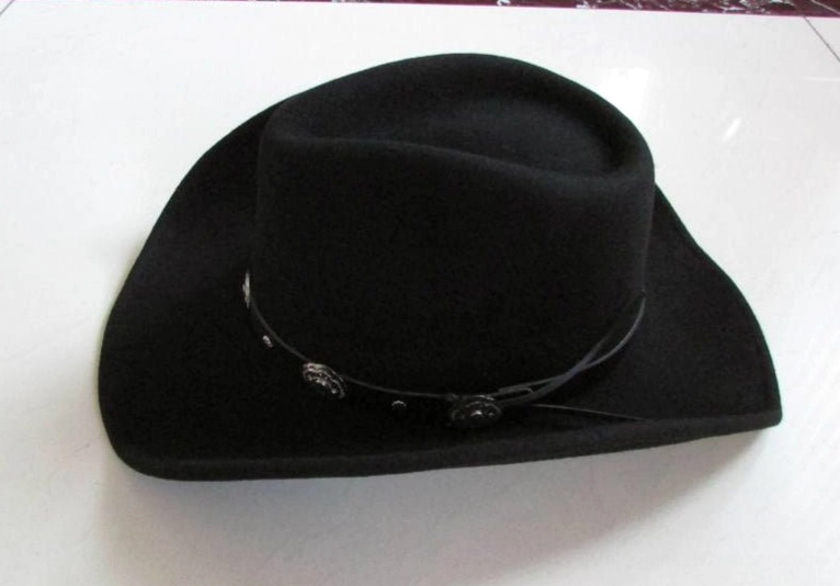 Black wool gothic cowboy hat side view with metal concho leather band and compact crown shape