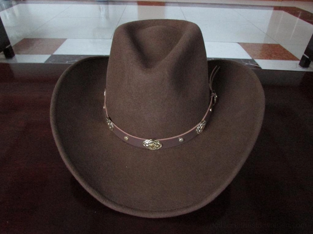 Brown wide brim gothic cowboy hat front three-quarter view with ornate metal conchos and curved brim