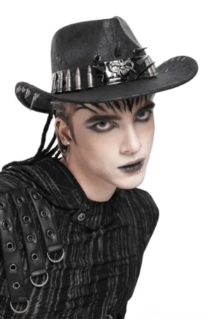 Black gothic cowboy hat with skull and bullet metal band worn by male model in left side profile view showcasing the detailed metallic embellishments
