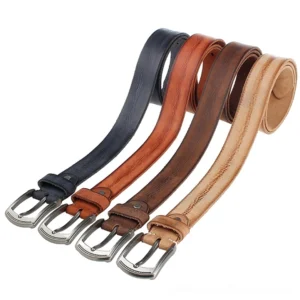 Assorted vintage distressed cowhide belts with alloy buckles in multiple gothic-inspired colors - overhead flat lay view