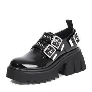 Black patent leather gothic loafers with shiny finish, dual metal buckle hardware, three-quarter view highlighting high-gloss upper and platform sole detail