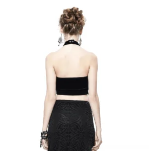Gothic halter crop top paired with patterned high-waist skirt, back view on female model, studio setting