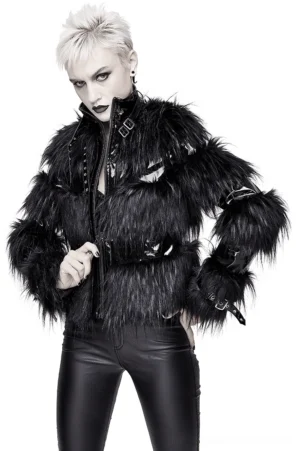 Black gothic cropped jacket with buckled high collar and faux fur panels, three-quarter front view on blonde punk model, studio photography