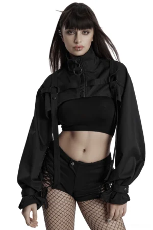 Black gothic cropped jacket with metal shoulder loops and ribbon straps worn by model, front three-quarter view showcasing harness strap details