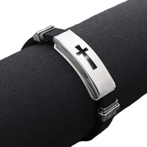 Close-up side view of polished silver titanium metal plate with black cross engraving and adjustable double safety clasp