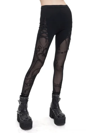 Gothic semi-sheer leggings with cross chain panels worn by model, side front view showing mesh details and ornate print