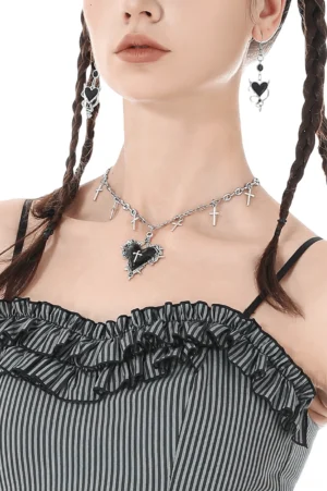 Silver cross charm heart pendant gothic necklace close-up detail with black enamel heart and ornate metalwork