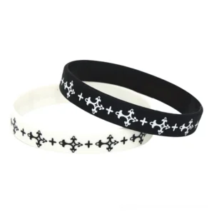 Gothic cross silicone wristband collection - black and white matte rubber bracelets with embossed cross pattern flat lay display