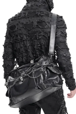 Gothic black tote bag worn as crossbody style, demonstrating adjustable shoulder strap and full rear design with chain accents