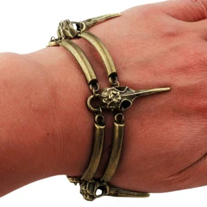 Crow skull chain bracelet worn on human wrist, side close-up shot showcasing double chain design and gothic jewelry styling