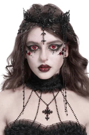 Black lace gothic crown headpiece with central cross pendant and beaded face chains on female model with dramatic gothic makeup, front close-up view