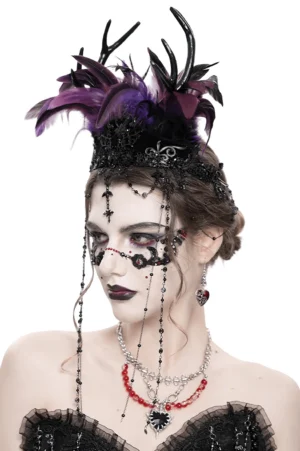 Three-quarter side angle of gothic feathered headpiece with dangling cross chain tassels on female goth styled model
