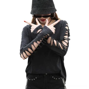 Close-up of black gothic pullover with fingerless cutout sleeves and round neckline on female model wearing bucket hat