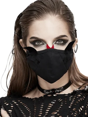 Gothic black cotton face mask with demon wings and red horns, worn by woman with dark makeup in studio setting