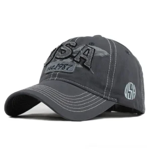 Gray washed denim gothic baseball cap with USA embroidery and contrasting topstitching, front oblique angle