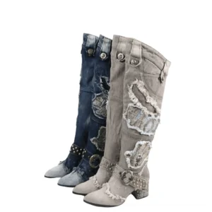 Studded denim gothic knee-high boots with embroidered patches, flat lay front view showing two color variants with rivet buckles and distressed details
