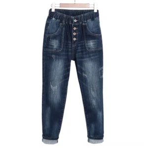 Dark distressed high-waist gothic denim jeans front flat lay view with button fly and front pockets detail