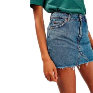 high-waist gothic denim mini skirt with raw frayed hem and front pockets front view on model