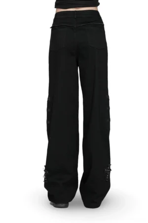 Black gothic denim pants rear view on female model, showcasing straight-leg silhouette and back pocket design with cross embellishments
