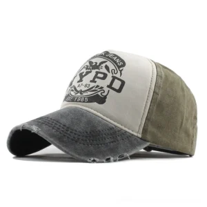 Distressed gothic 5-panel baseball cap with NYPD letter print in black and gray colorway, front three-quarter view showing frayed brim and color-blocked design