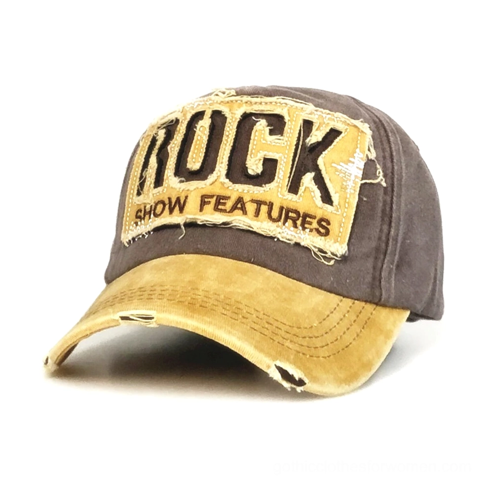 Distressed gothic baseball cap with ROCK SHOW FEATURES embroidery in brown and yellow, front 3/4 view showing frayed brim and two-tone distressed cotton fabric