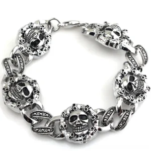 Double skull stainless steel gothic chain bracelet, vintage silver tone finish, flat lay on white background showcasing 3D engraved skull charms and curb chain design