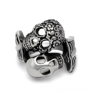 Dual skull gothic stainless steel ring front view showing two distinct carved skull designs with vintage silver finish