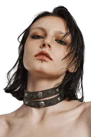 Close-up front view of gothic double strap choker on model's neck, highlighting layered metal studded straps and chain closure mechanism