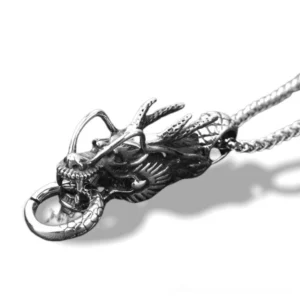 Antique silver dragon head pendant necklace showing detailed carved facial features and scales, displayed against white background