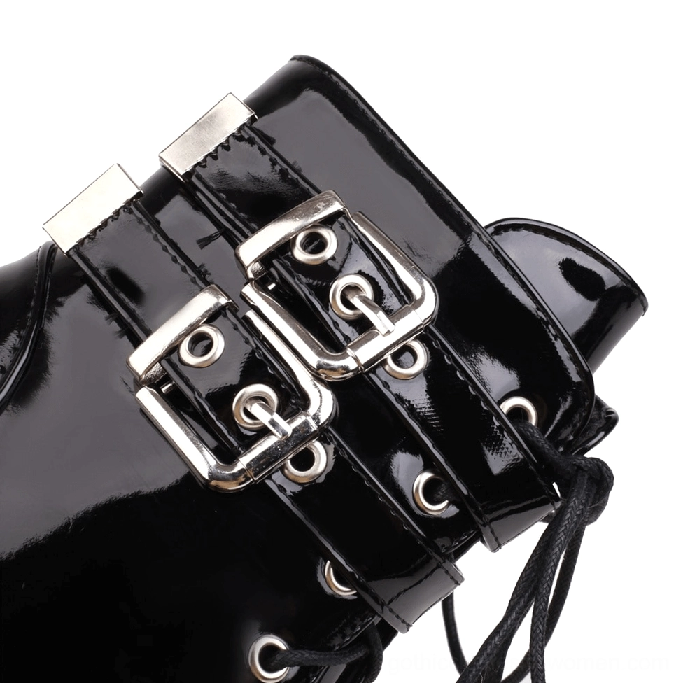 Close-up of gothic platform boots ankle strap with dual silver metal buckles and lace cords detail