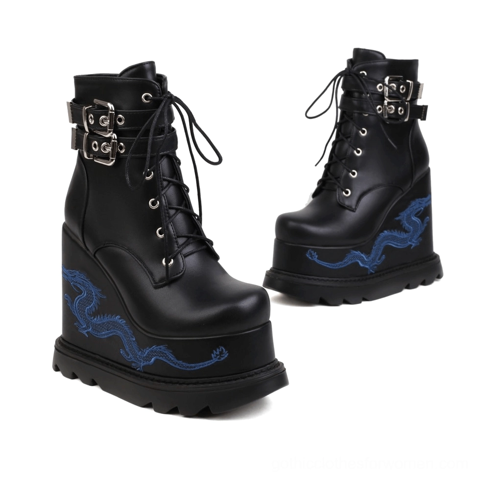 Pair of black matte leather dragon embroidered goth platform wedge ankle boots with blue embroidery side-by-side