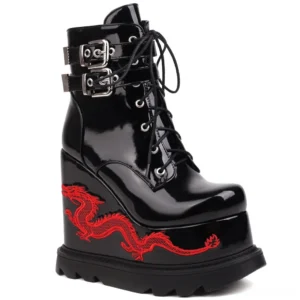 Black patent leather dragon embroidered gothic platform wedge ankle boots with red embroidery and dual metal buckles, left three-quarter view