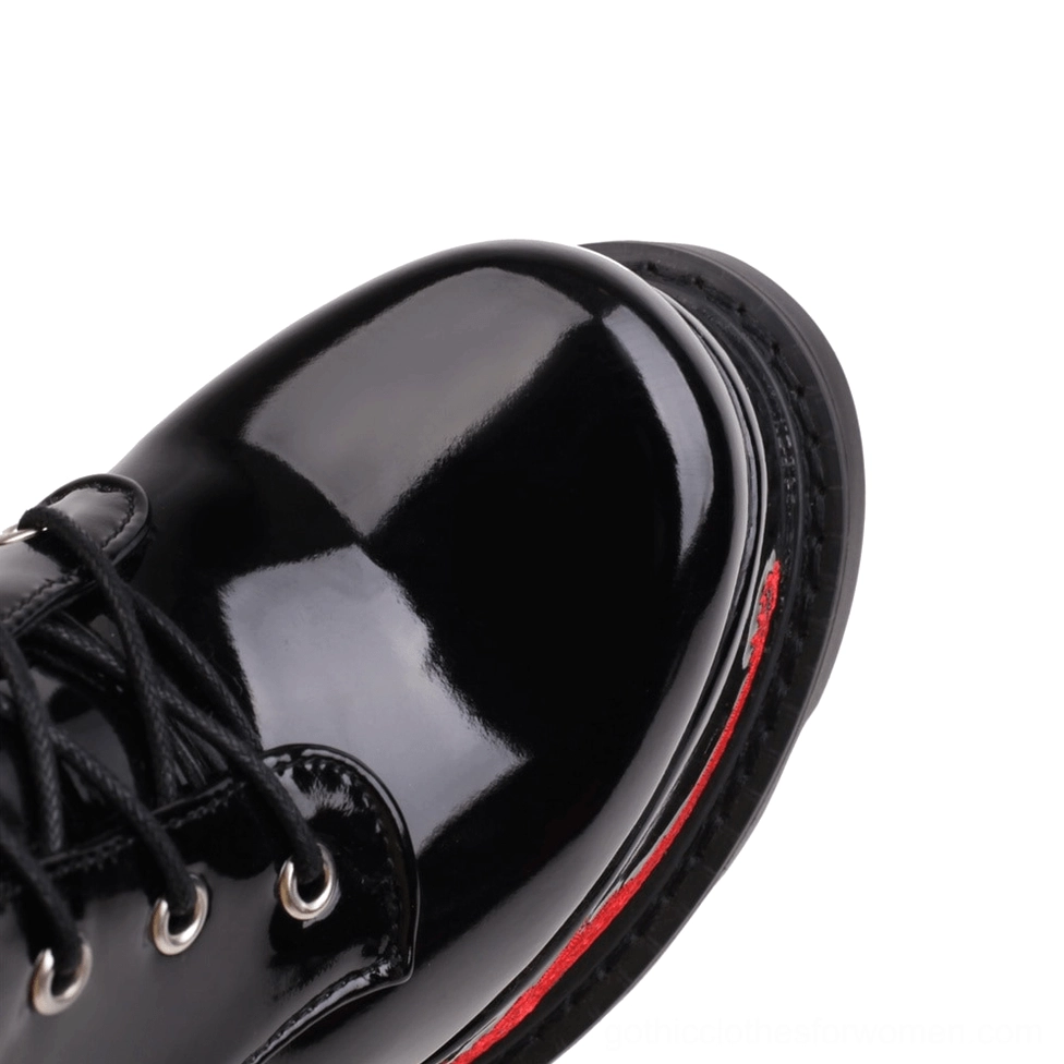 Close-up of gothic dragon platform boots toe cap with patent leather and metal lace eyelets
