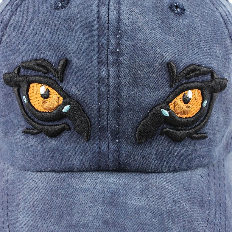 Double eagle eye embroidery close-up 3D stitching orange blue accents gothic symbolism