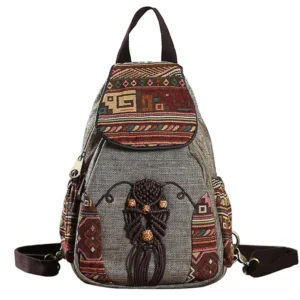 Gothic embroidered canvas backpack front view with tribal woven patterns and handcrafted tassel details on light background